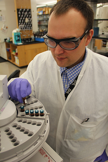 Nick Baumhover, analytical
chemist, places samples
that will be analyzed for
pesticide residue on an autosampler
tray for analysis by
gas chromatographymass
spectrometry (GC-MS).